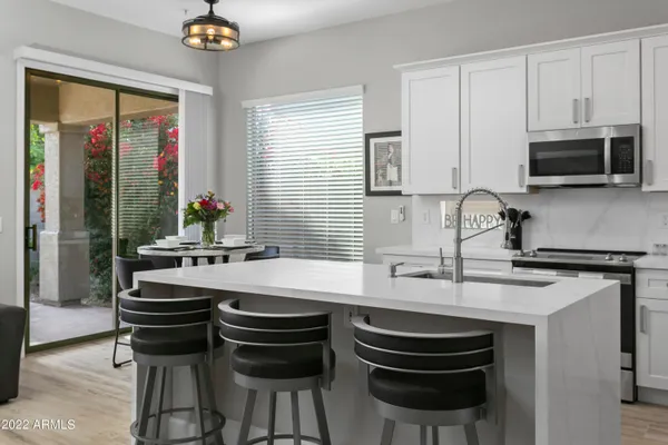 a kitchen with a stove a sink and a refrigerator