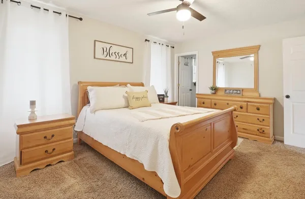 a spacious bedroom with a bed and a cabinets