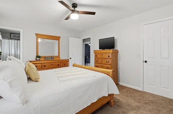 a bedroom with a bed and a television