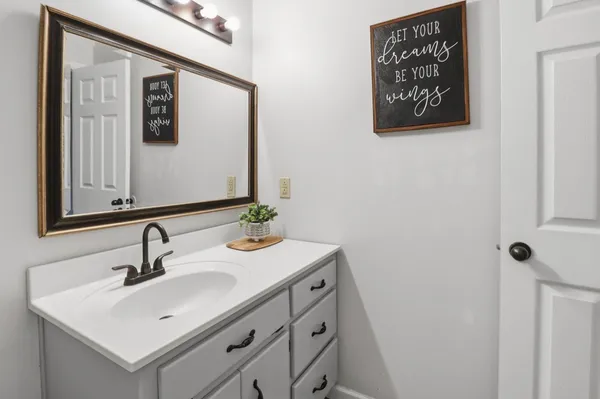 a bathroom with a sink and a mirror