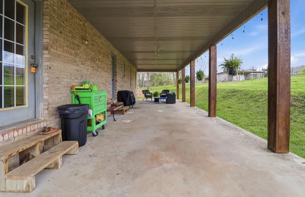 a view of a porch with furniture and garden