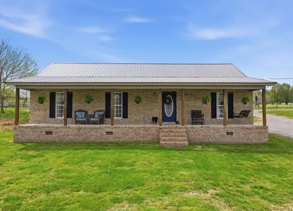 a front view of a house with a garden and patio
