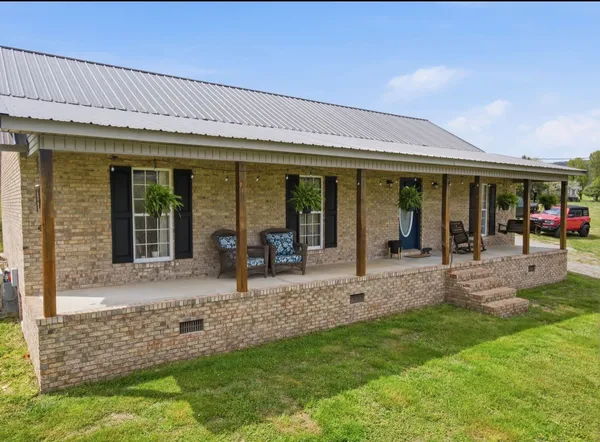 a view of a house with outdoor seating area
