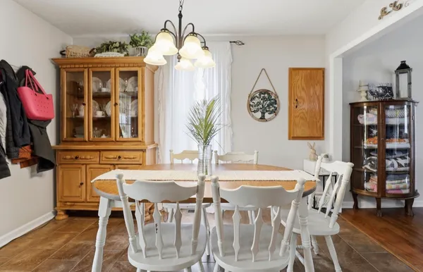 a view of a dining room with furniture and chandelier