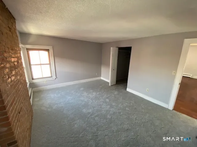 an empty room with windows and closet