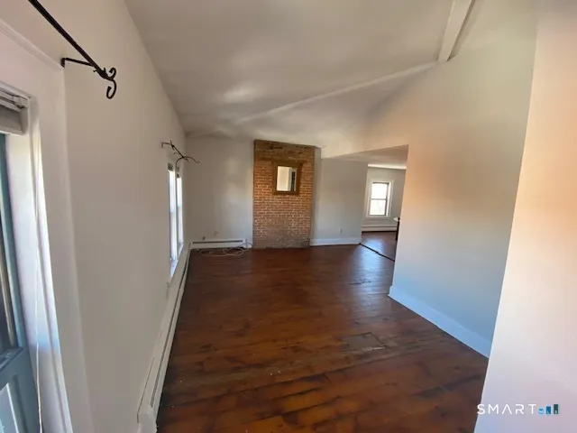 a view of hallway with wooden floor