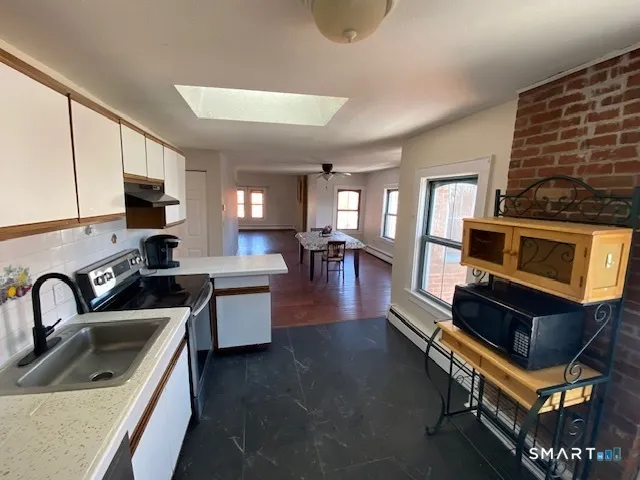 a kitchen with a sink appliances and cabinets