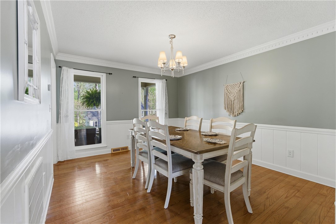 114 Halifax Road Easley, SC 29642 - Photo 10 of 32 This inviting dining area features crown molding, hardwood floors, and abundant natural light.