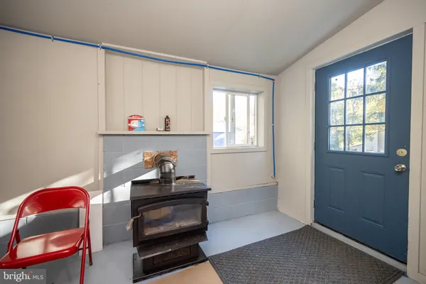 a view of an empty room and window and wooden floor