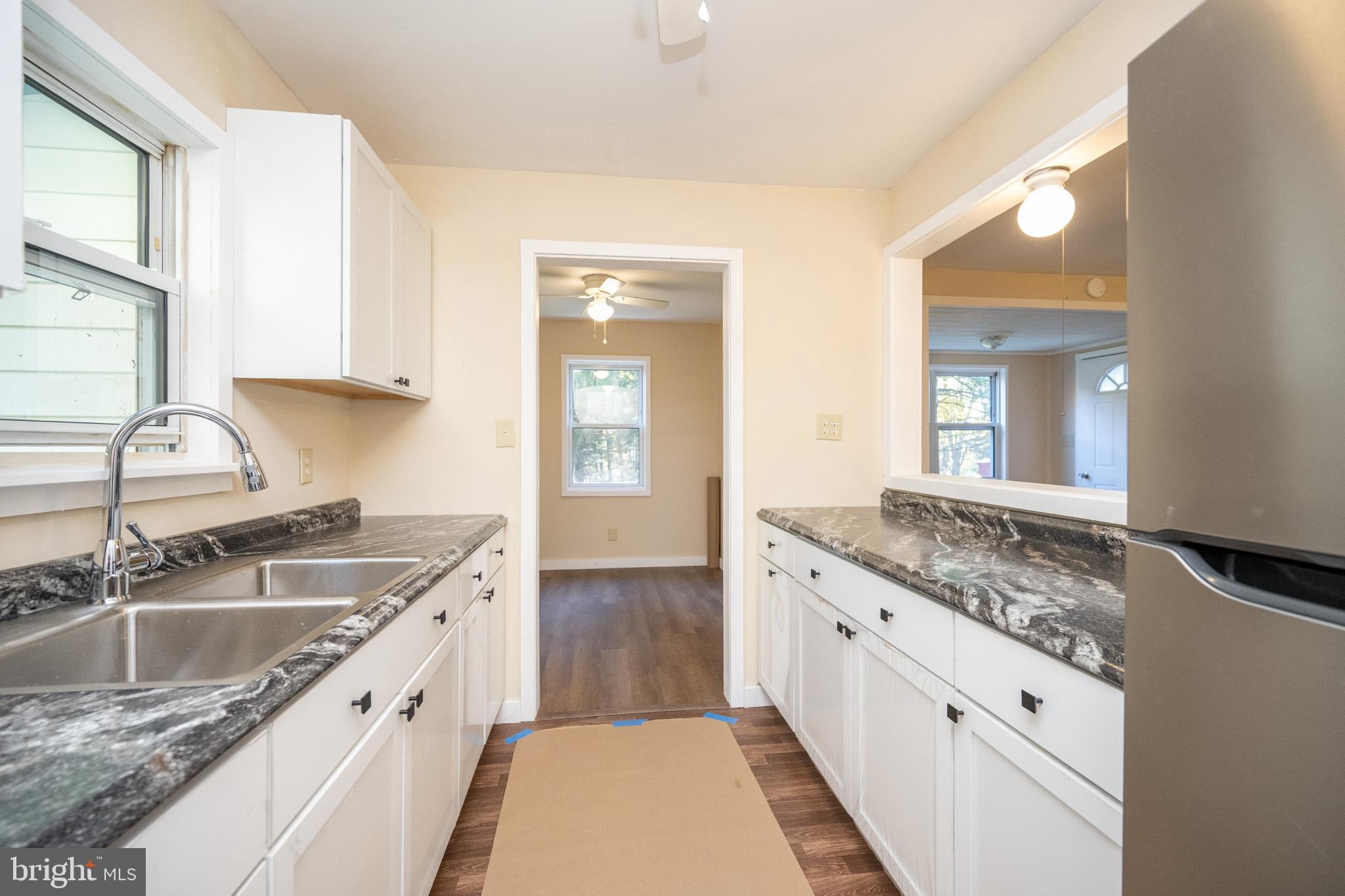 63 Wallman Road Oakland, MD 21550 - Photo 29 of 60 a kitchen with a sink stove and cabinets