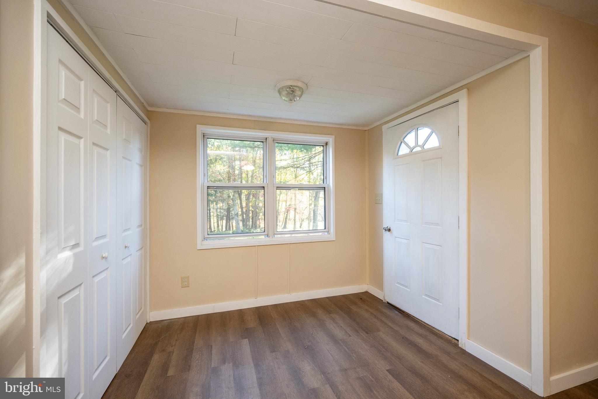 63 Wallman Road Oakland, MD 21550 - Photo 31 of 60 an empty room with wooden floor and windows
