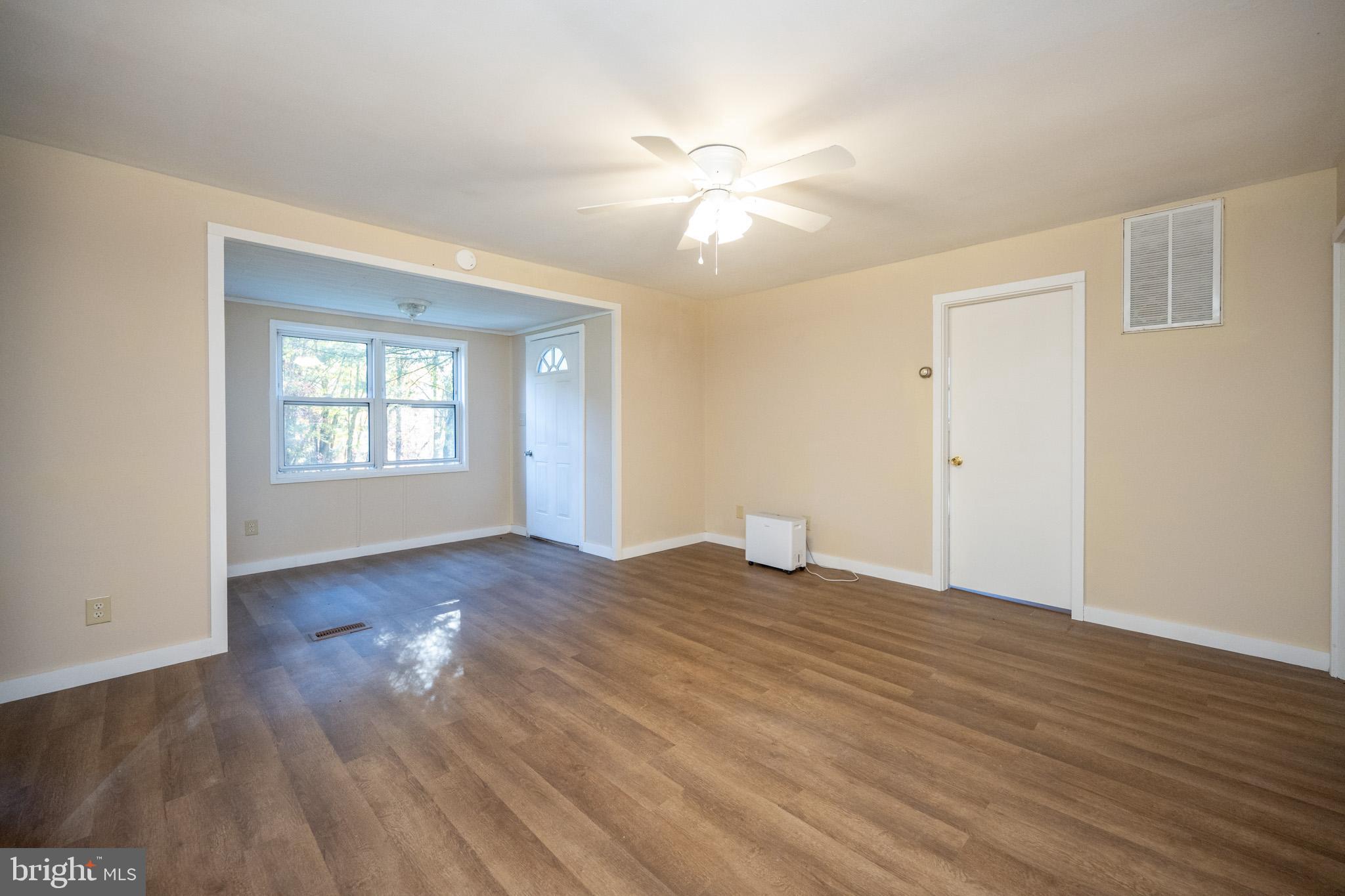 63 Wallman Road Oakland, MD 21550 - Photo 34 of 60 a view of an empty room with wooden floor and a window