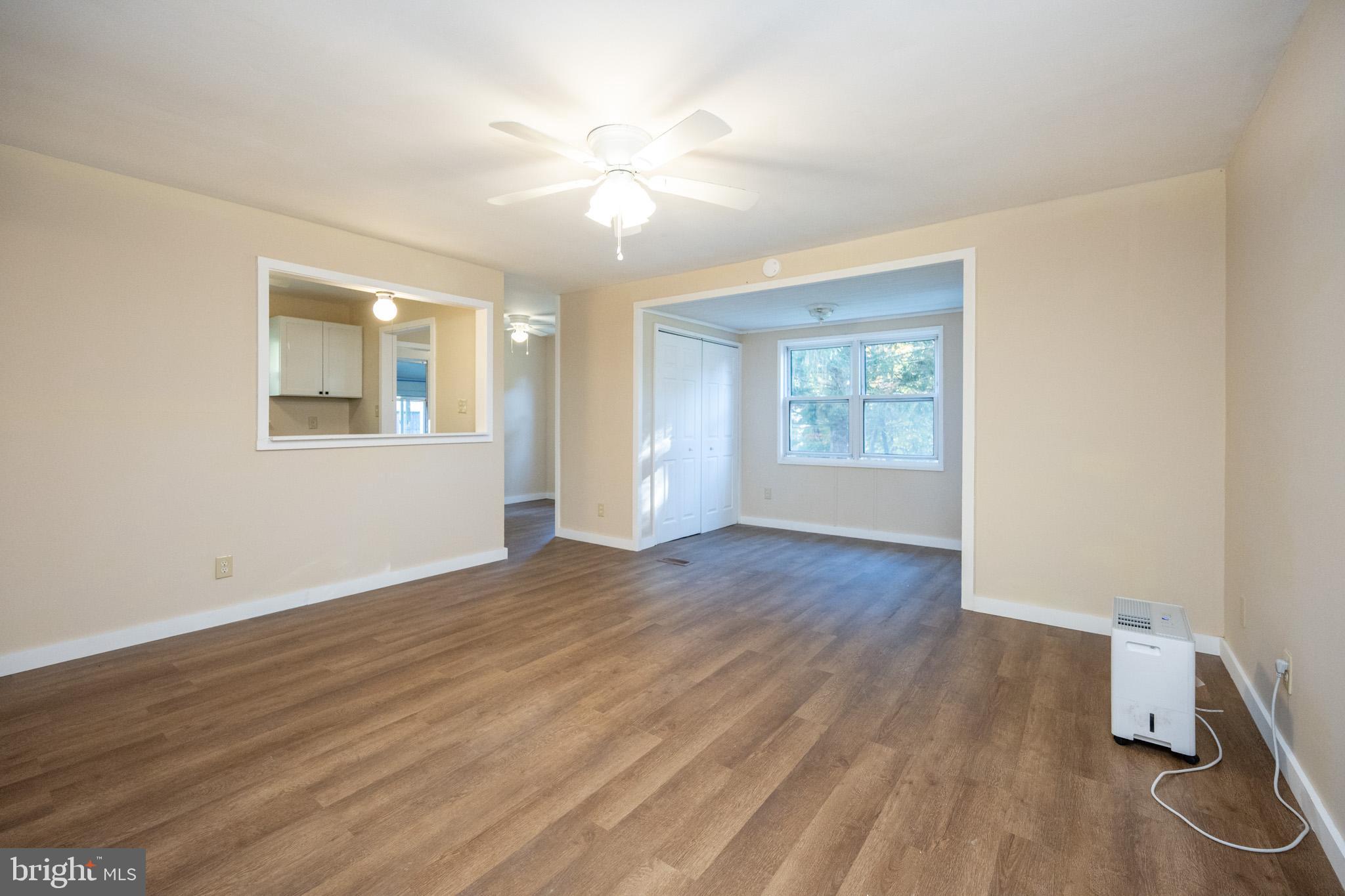 63 Wallman Road Oakland, MD 21550 - Photo 35 of 60 a view of an empty room with wooden floor and a window