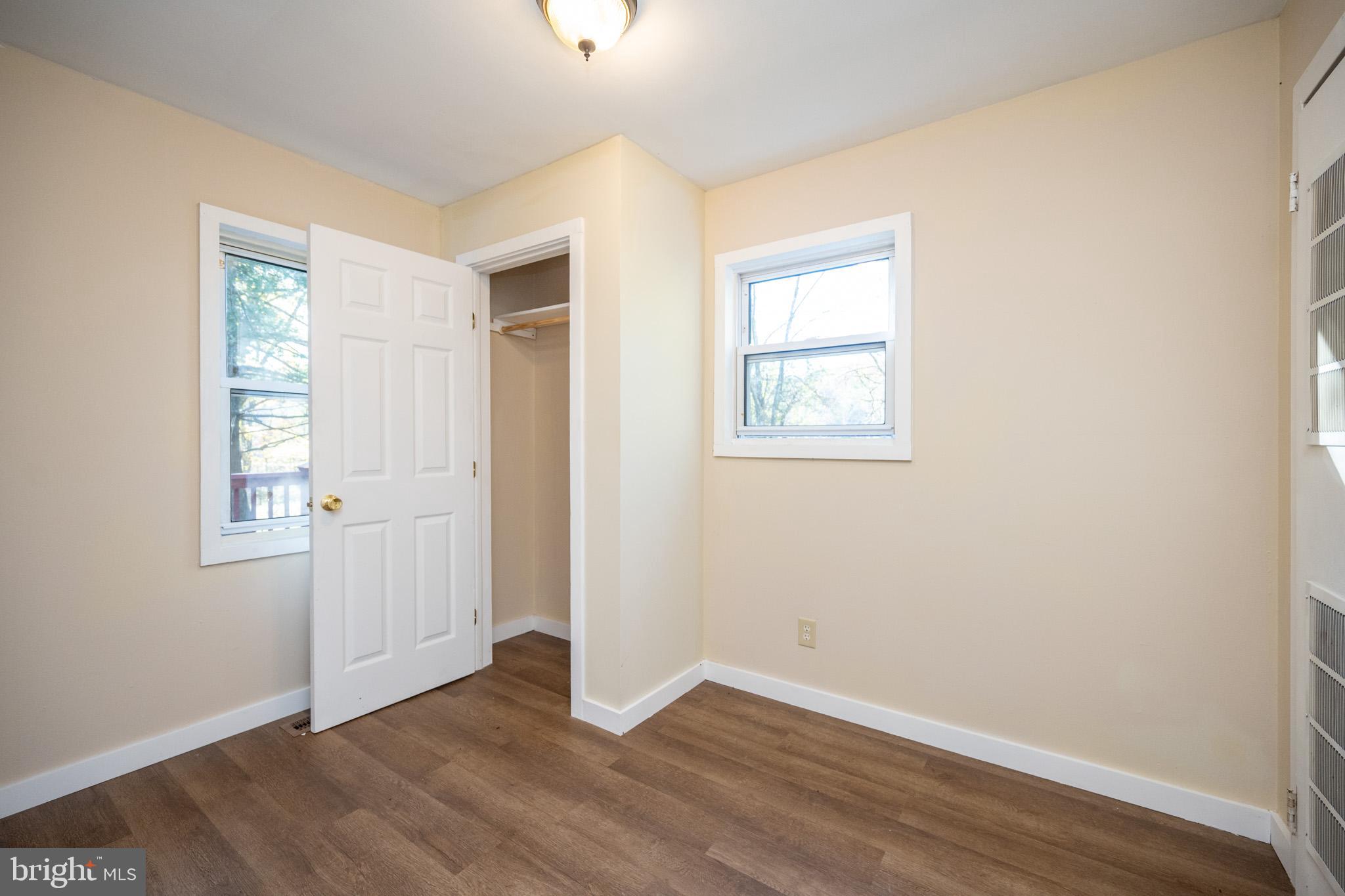 63 Wallman Road Oakland, MD 21550 - Photo 40 of 60 an empty room with wooden floor and windows