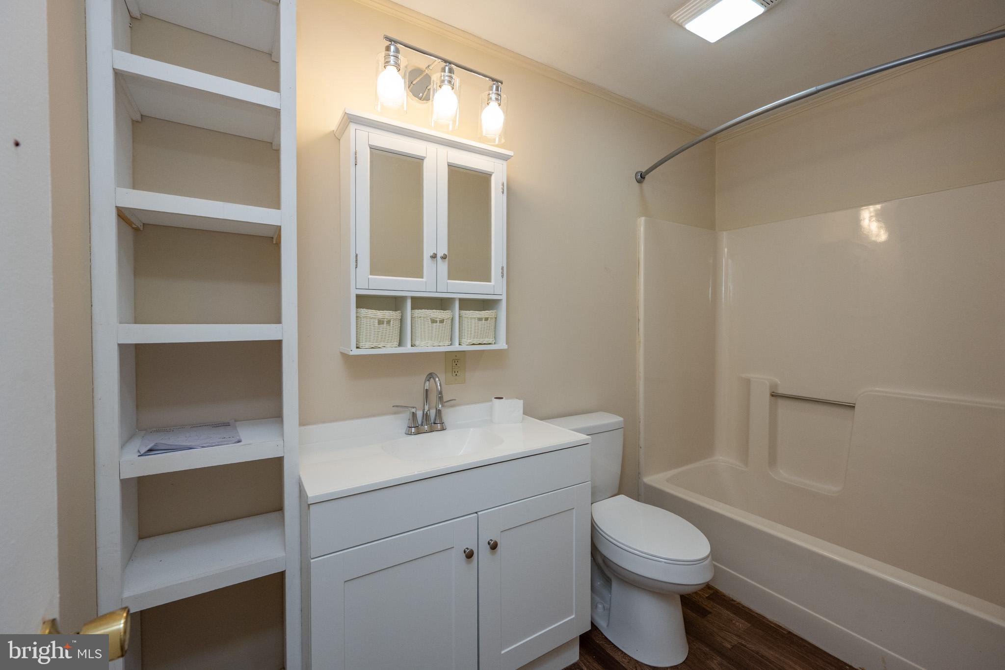63 Wallman Road Oakland, MD 21550 - Photo 44 of 60 a bathroom with a sink toilet vanity and tub