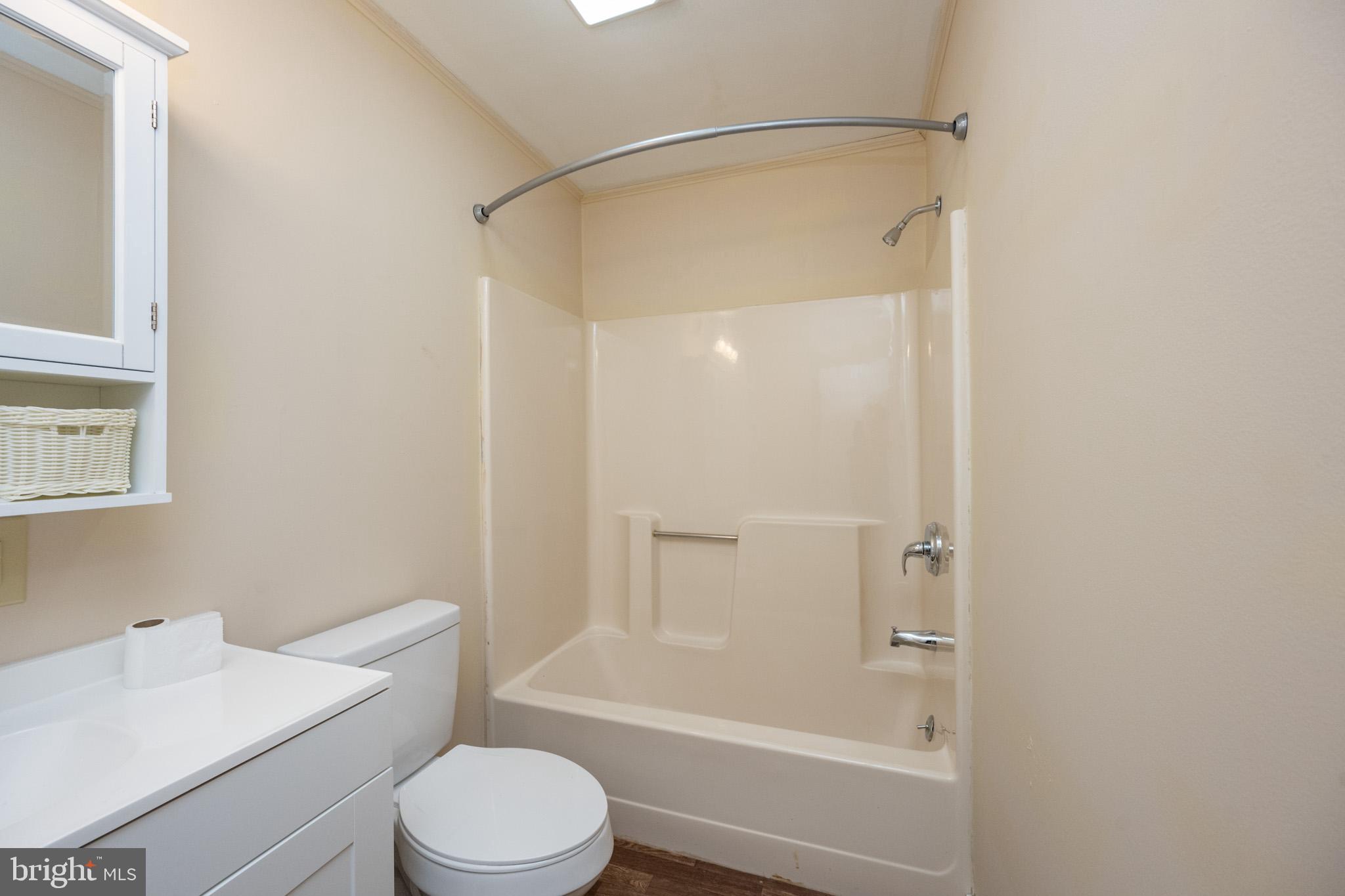 63 Wallman Road Oakland, MD 21550 - Photo 45 of 60 a white toilet and tub sitting next to a bathroom sink