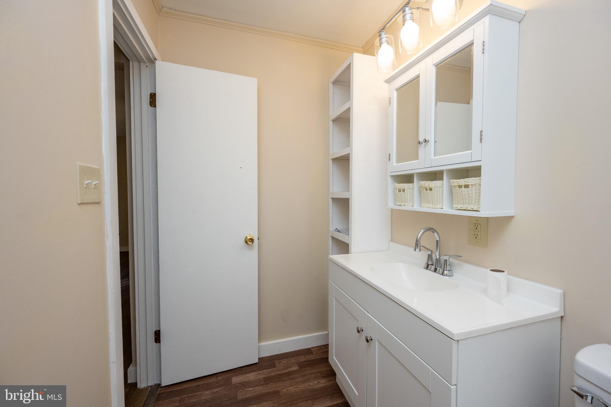 63 Wallman Road Oakland, MD 21550 - Photo 46 of 60 a bathroom with a sink toilet and a mirror