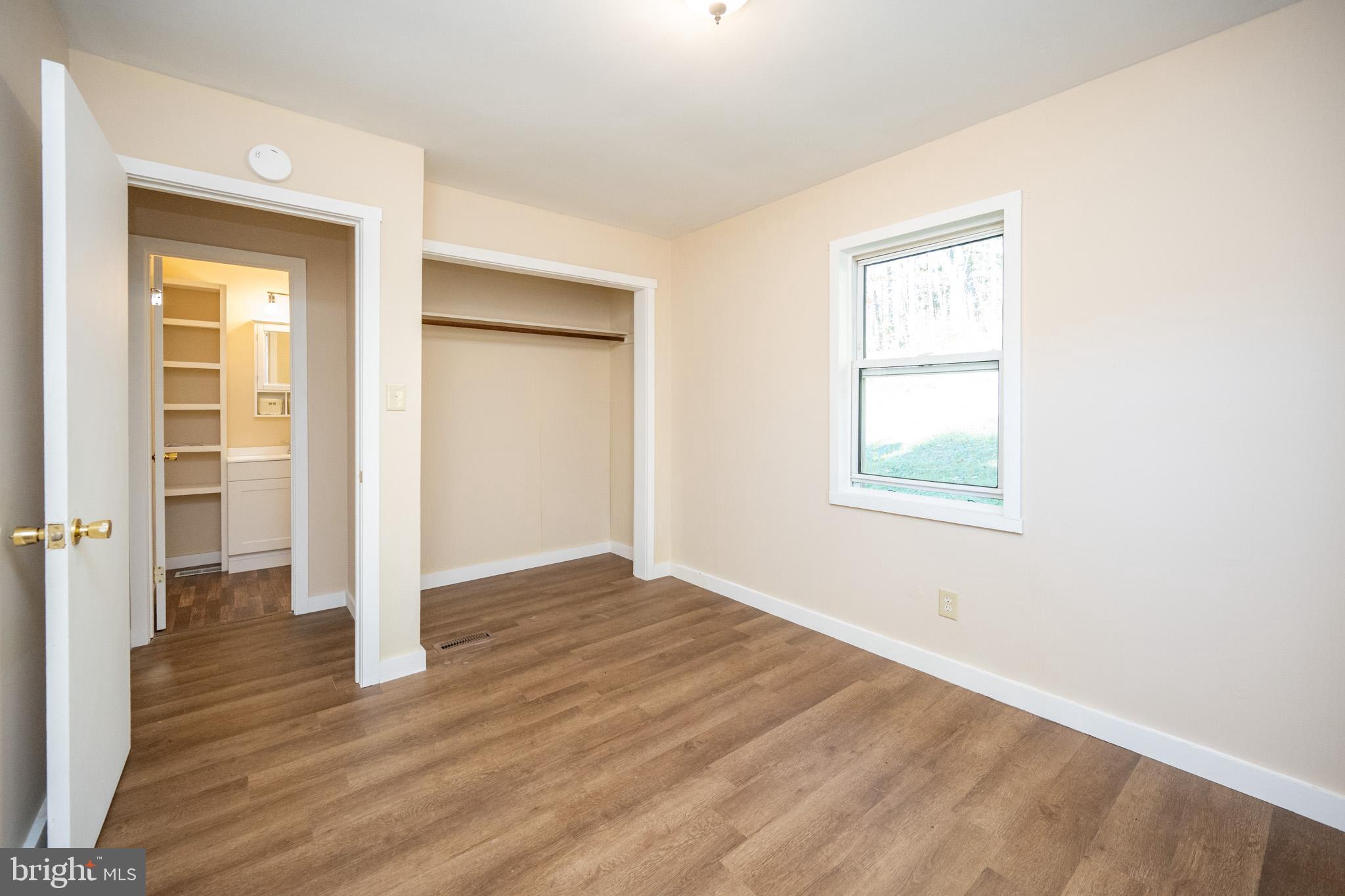 63 Wallman Road Oakland, MD 21550 - Photo 48 of 60 an empty room with wooden floor and windows