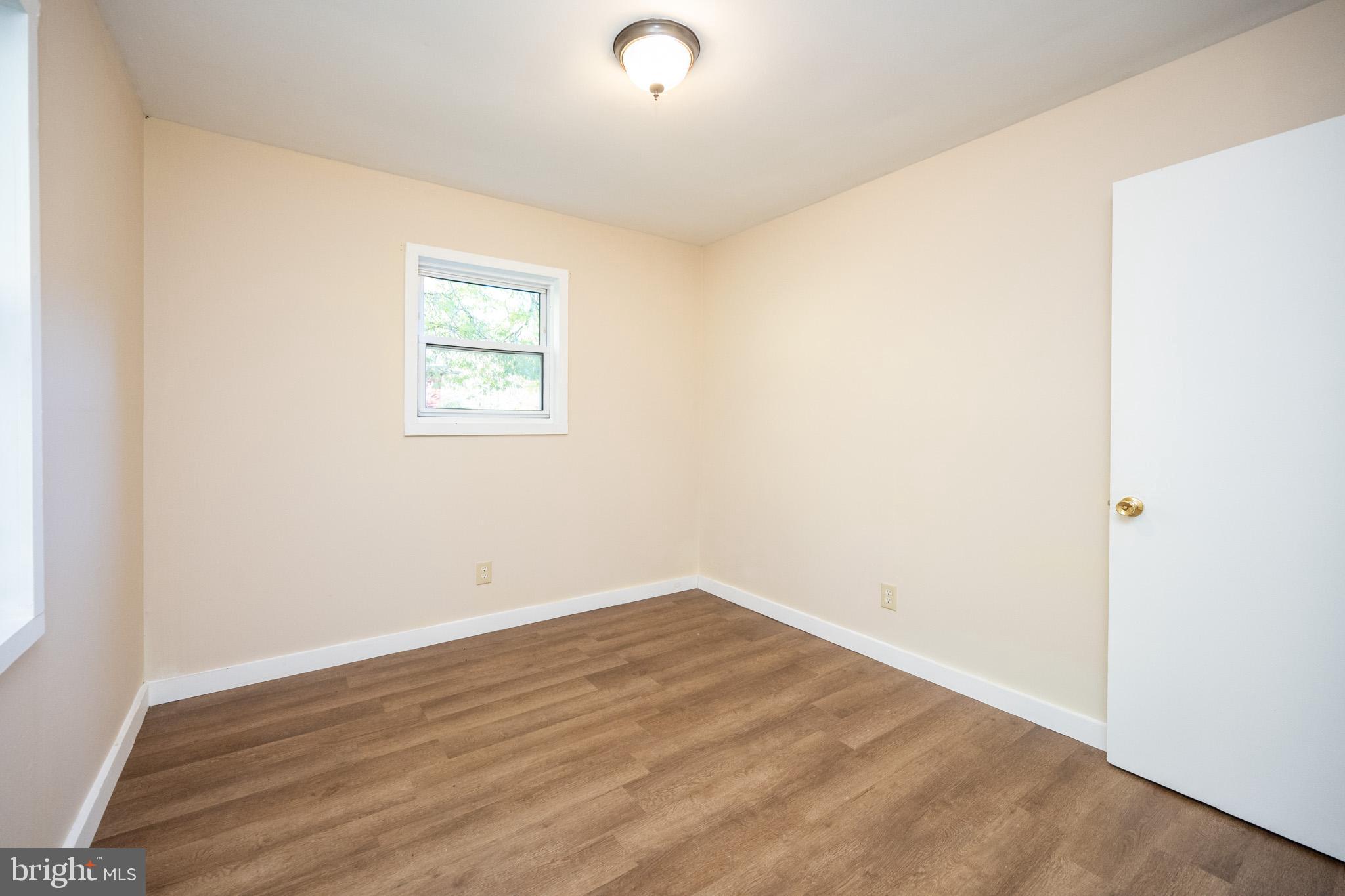 63 Wallman Road Oakland, MD 21550 - Photo 50 of 60 an empty room with wooden floor and windows