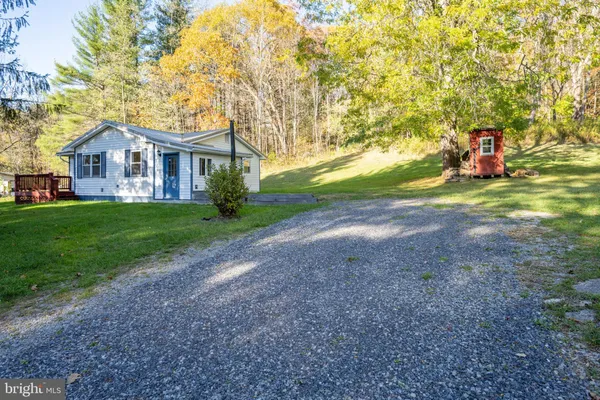 a view of a house with a yard and deck