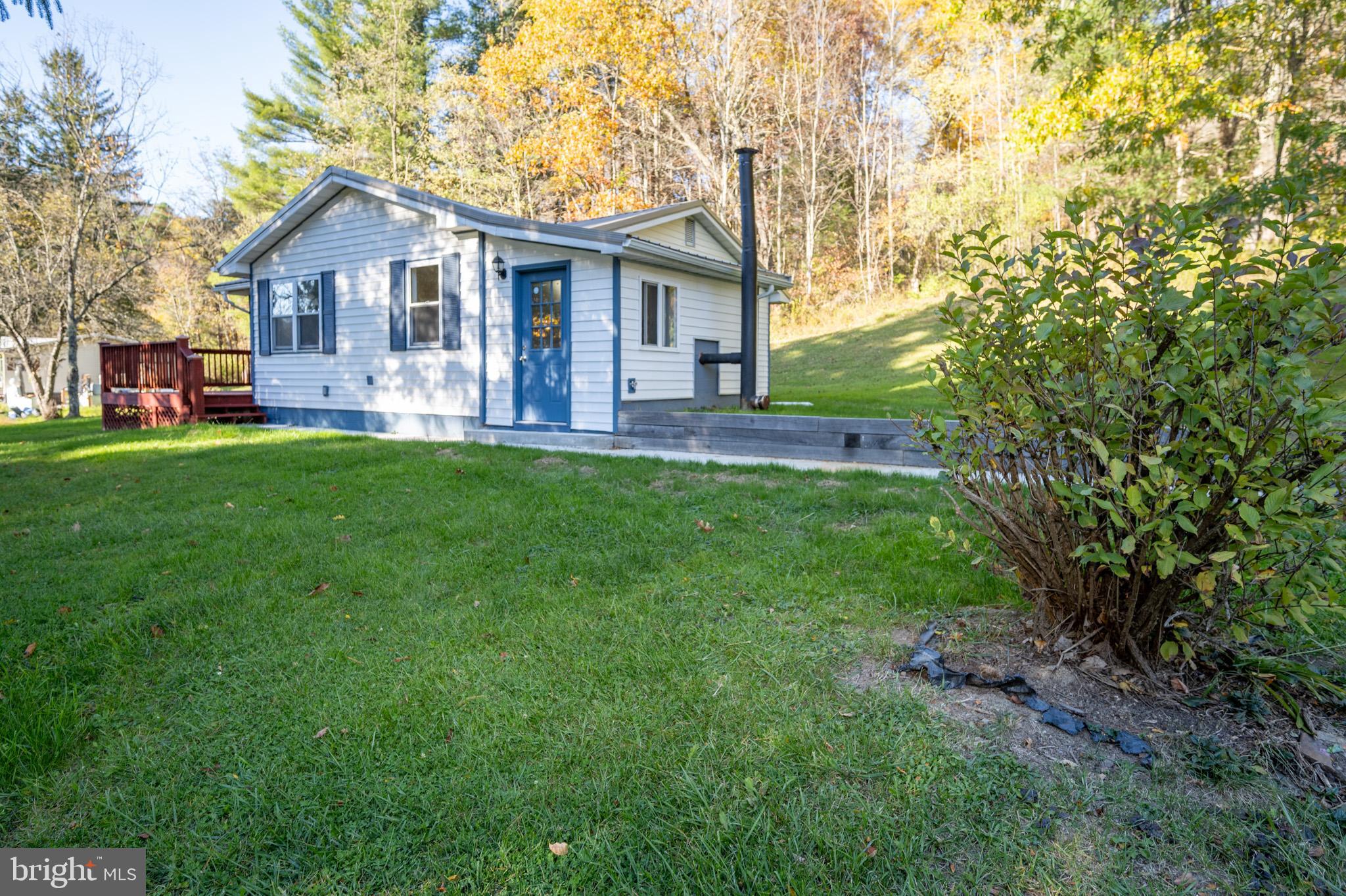 63 Wallman Road Oakland, MD 21550 - Photo 6 of 60 a front view of a house with a yard and green space