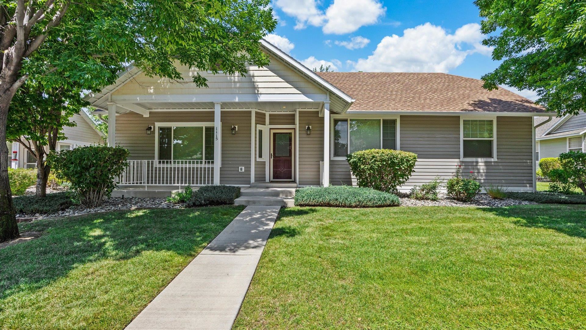 a view of a house with a yard and plants