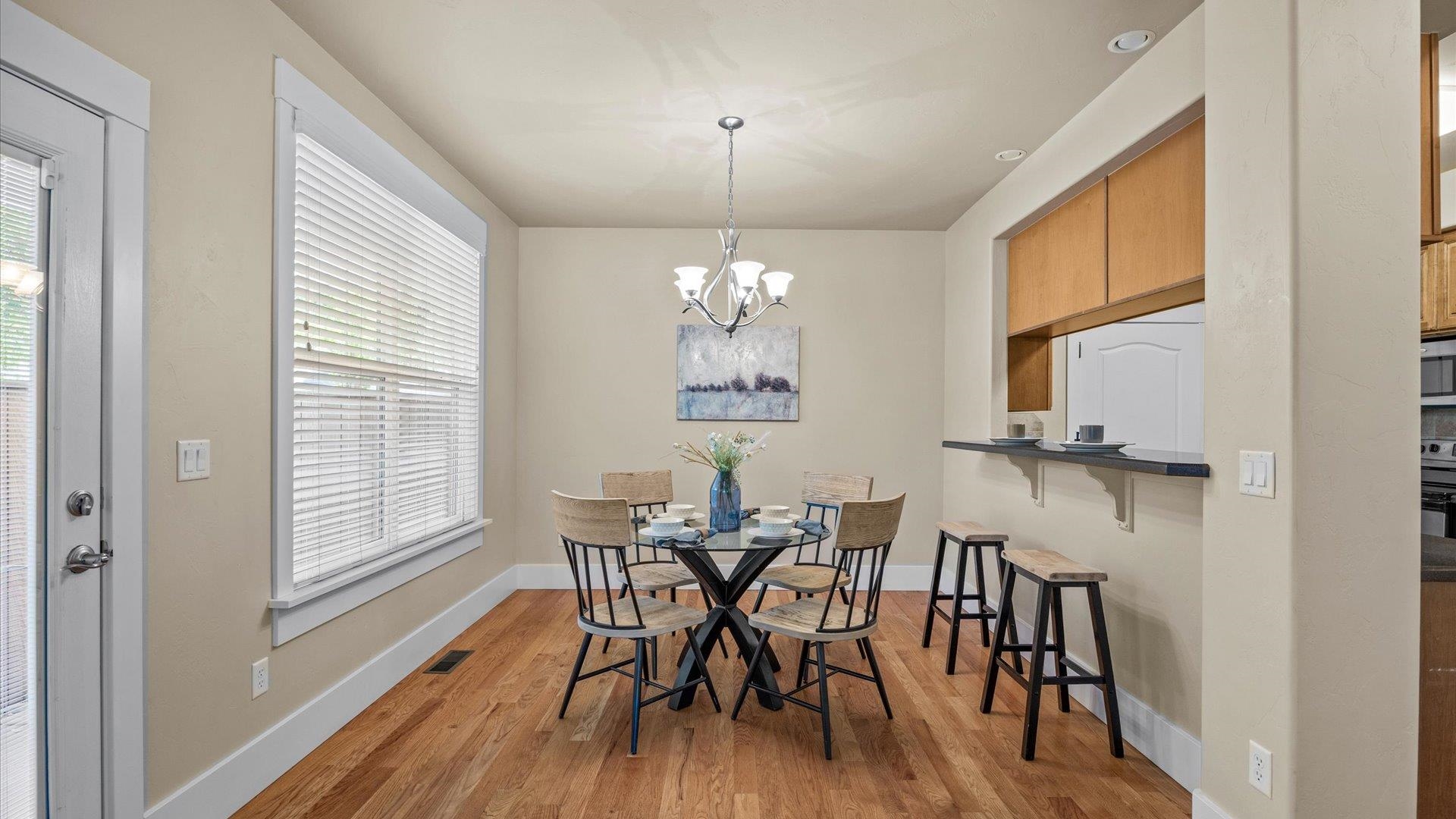 1115 Sunrose Lane Fruita, CO 81521 - Photo 11 of 32 a view of a dining room with furniture window and wooden floor