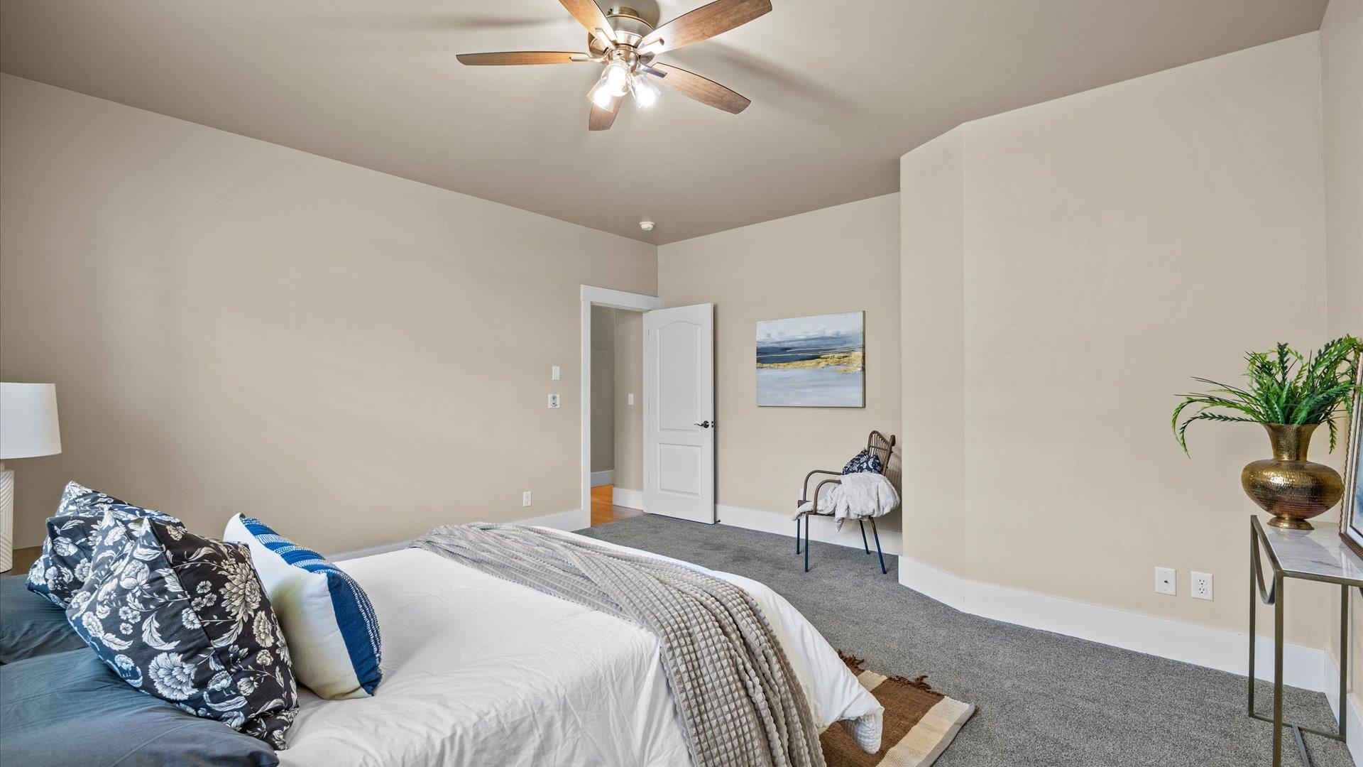 1115 Sunrose Lane Fruita, CO 81521 - Photo 12 of 32 a bedroom with a bed and a potted plant