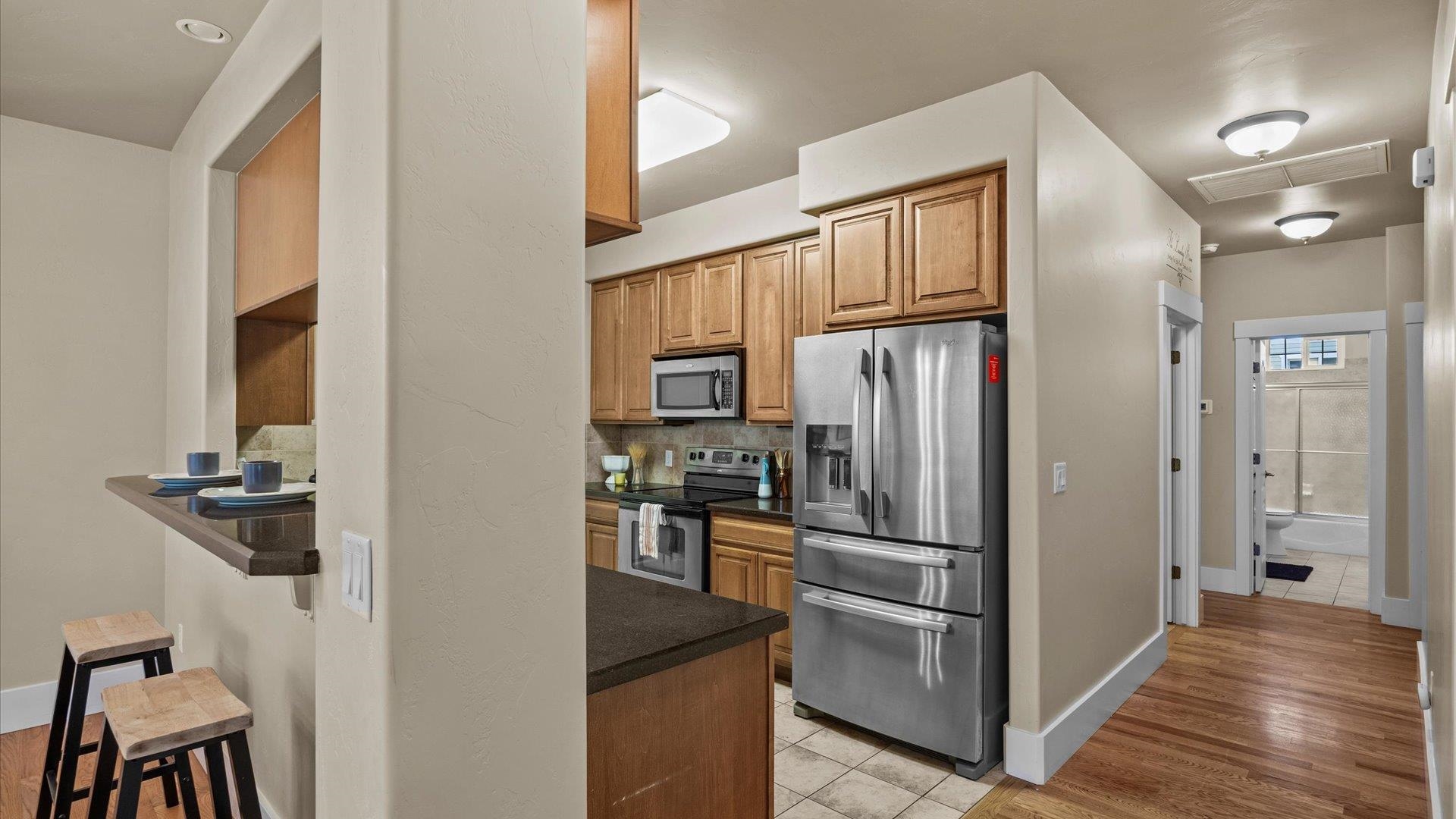 1115 Sunrose Lane Fruita, CO 81521 - Photo 6 of 32 a kitchen with stainless steel appliances granite countertop a refrigerator and a stove top oven
