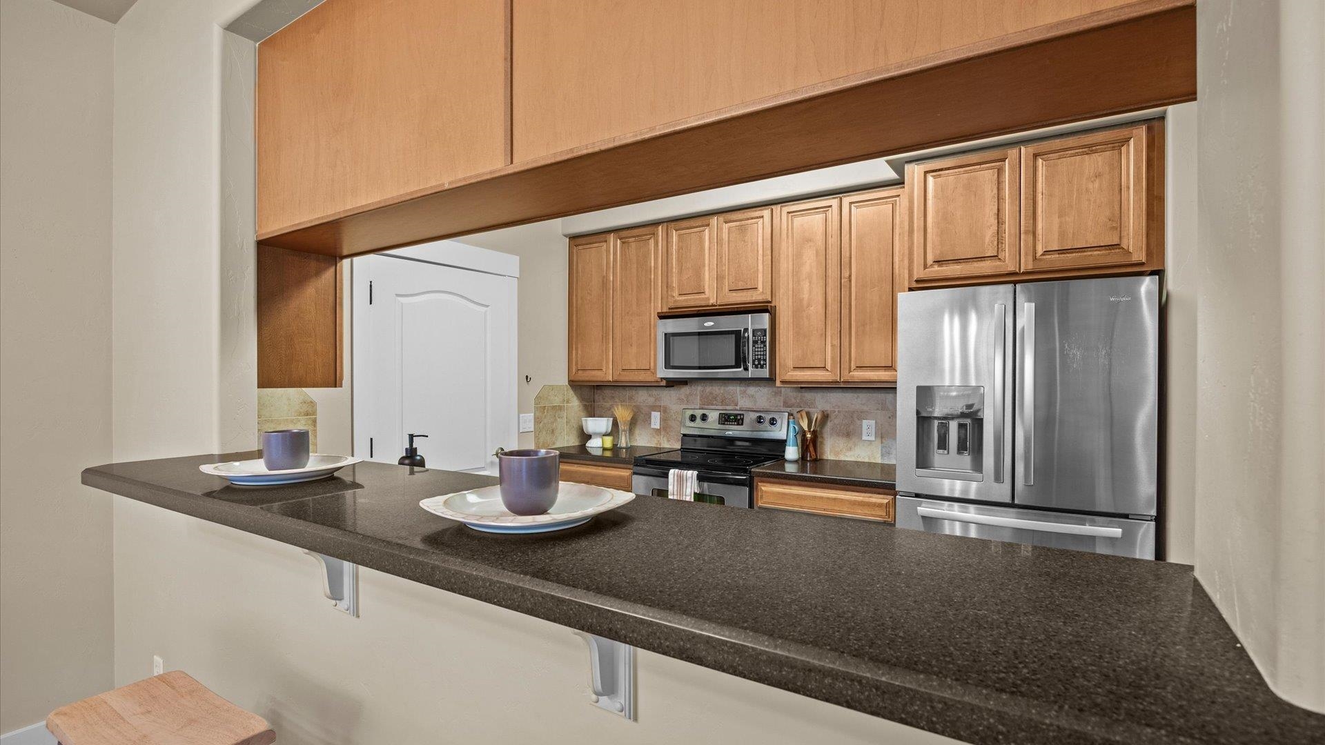 1115 Sunrose Lane Fruita, CO 81521 - Photo 8 of 32 a kitchen with sink a refrigerator and cabinets