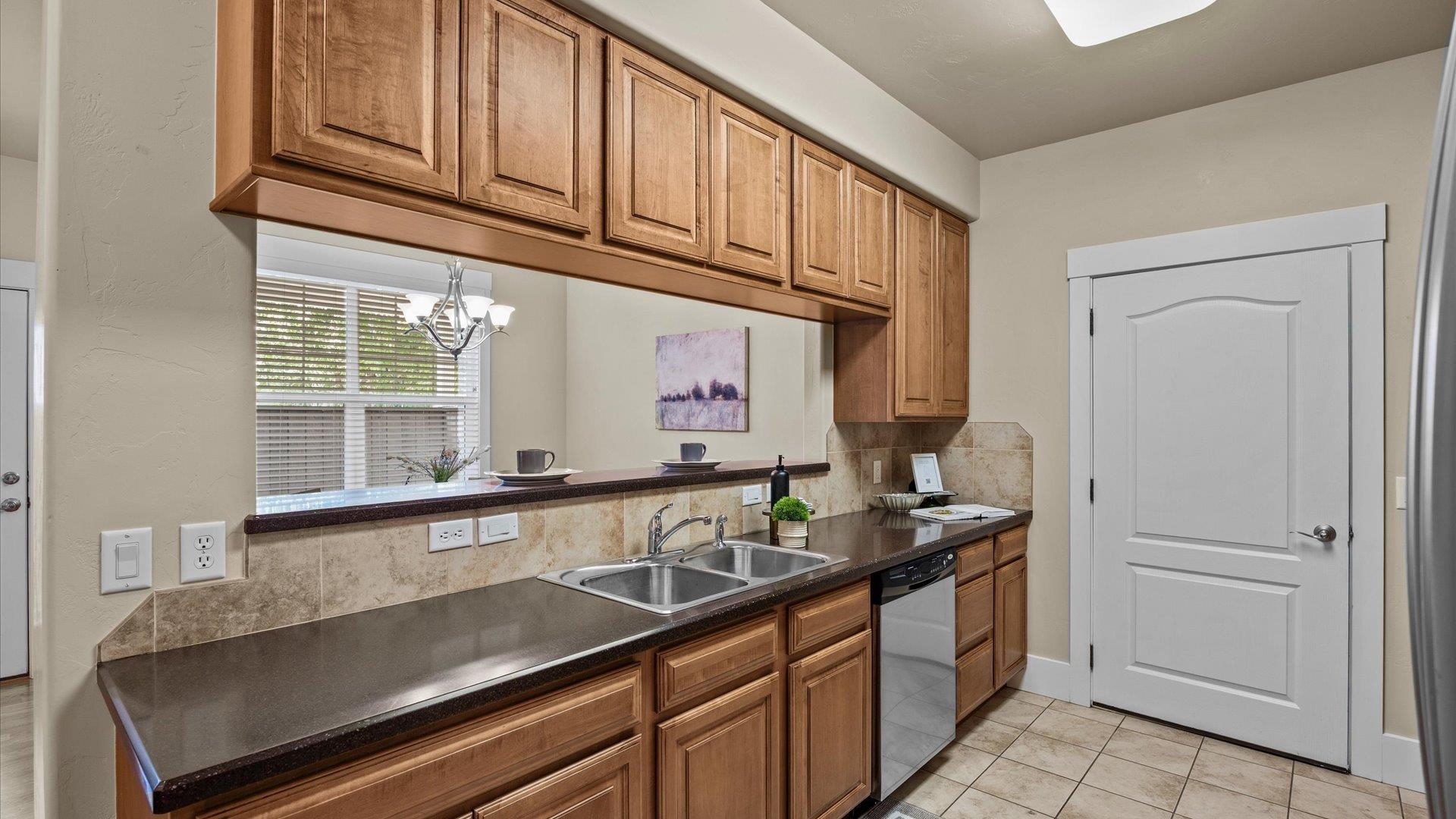 1115 Sunrose Lane Fruita, CO 81521 - Photo 9 of 32 a kitchen with stainless steel appliances granite countertop a sink and cabinets