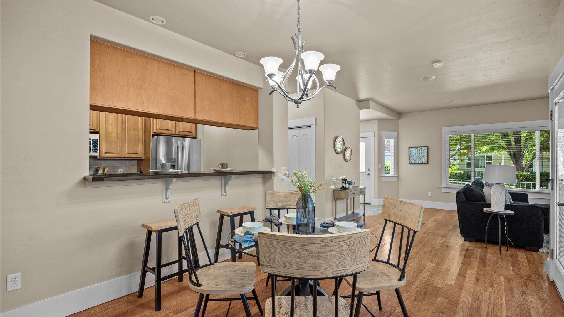 1115 Sunrose Lane Fruita, CO 81521 - Photo 10 of 32 a view of a dining room with furniture a chandelier and wooden floor