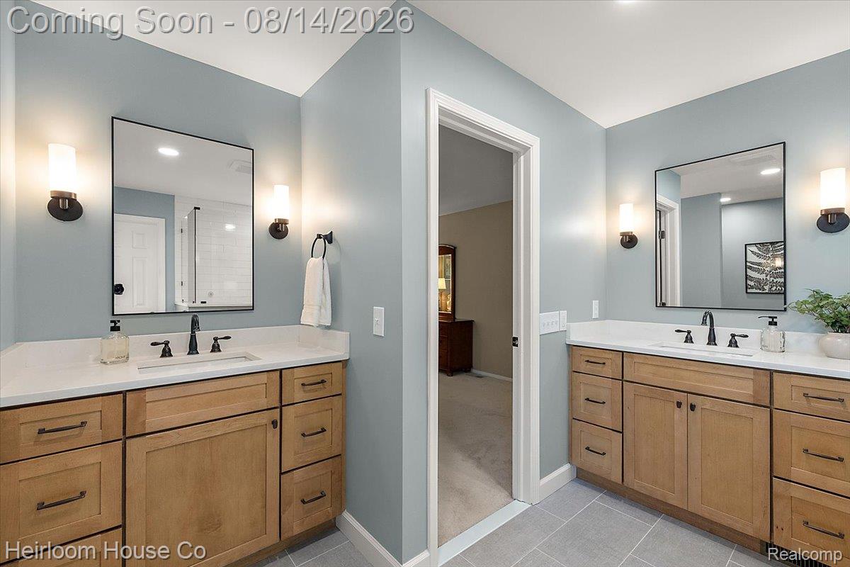 45697 Bryn Mawr Road Canton, MI 48187 - Photo 42 of 75 Bathroom featuring twin wood-finish vanities with solid surface countertops and undermount sinks