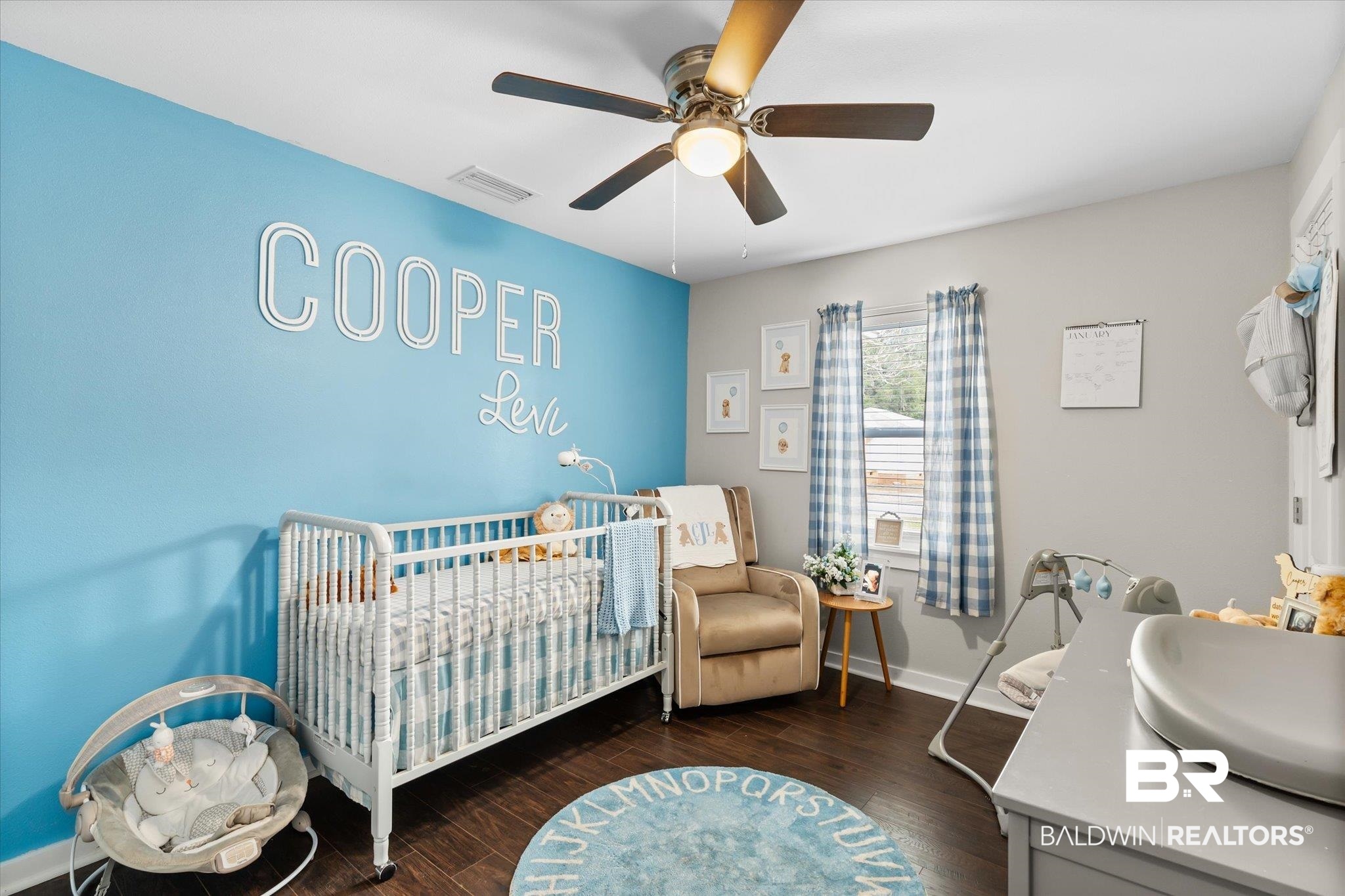 419 Pierce Street Saraland, AL 36571 - Photo 14 of 21 Bedroom featuring a crib, dark hardwood / wood-style floors, sink, and ceiling fan
