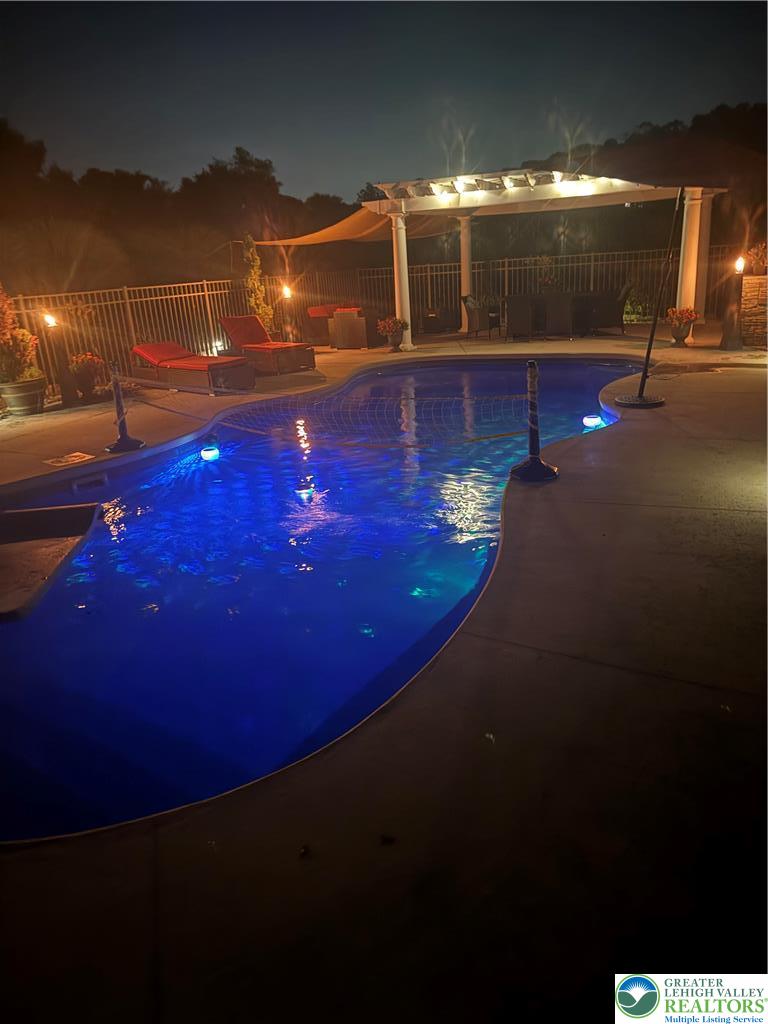 101 Cider Mill Road Mertztown, PA 19539 - Photo 13 of 26 a view of a swimming pool with an outdoor space and seating area