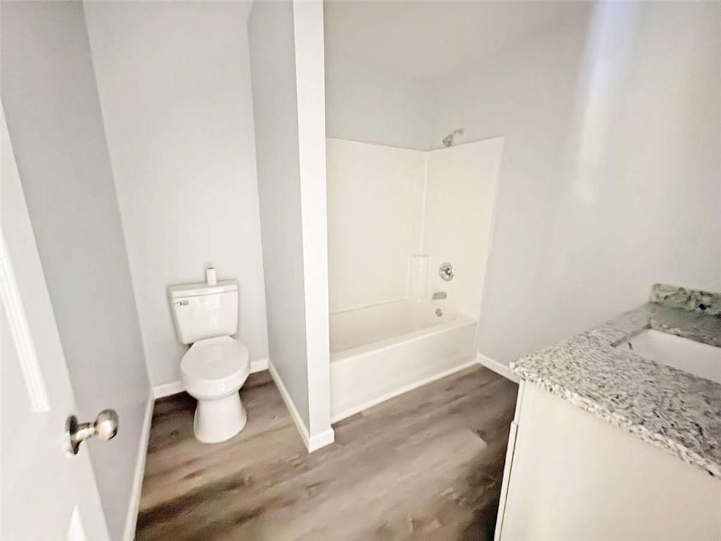 24 George Street Forsyth, GA 31029 - Photo 6 of 17 a bathroom with a granite countertop sink toilet and shower