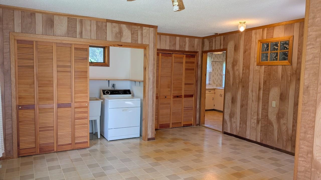 8159 Ludlow Road Cook, MN 55723 - Photo 11 of 32 Washroom with washer / dryer, wooden walls, ceiling fan, healthy amount of natural light, and light floors