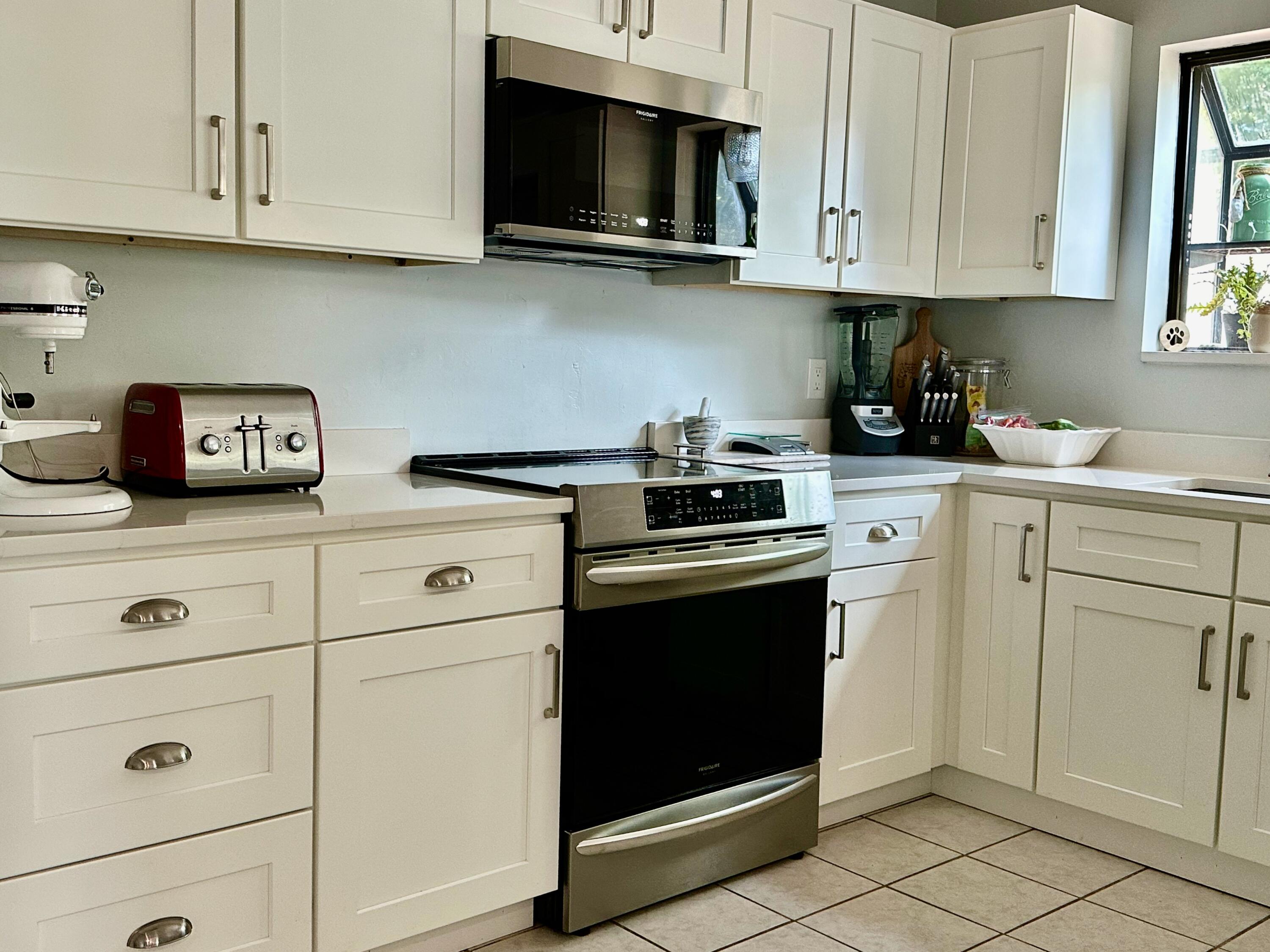 21 Round House Road Bourne, MA 02532 - Photo 9 of 21 a kitchen with white cabinets and stainless steel appliances