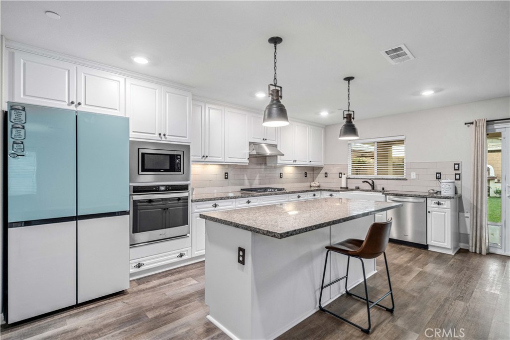 44451 63rd Street West Lancaster, CA 93536 - Photo 13 of 47 a kitchen with a sink a counter space appliances and cabinets