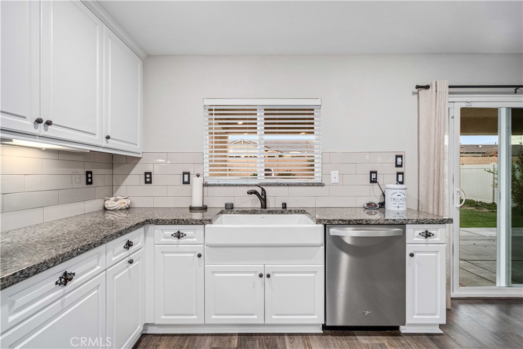 44451 63rd Street West Lancaster, CA 93536 - Photo 14 of 47 a kitchen with granite countertop a sink stainless steel appliances and white cabinets