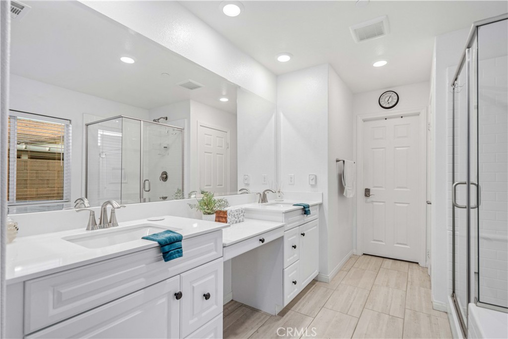44451 63rd Street West Lancaster, CA 93536 - Photo 20 of 47 a spacious bathroom with a double vanity sink mirror and shower