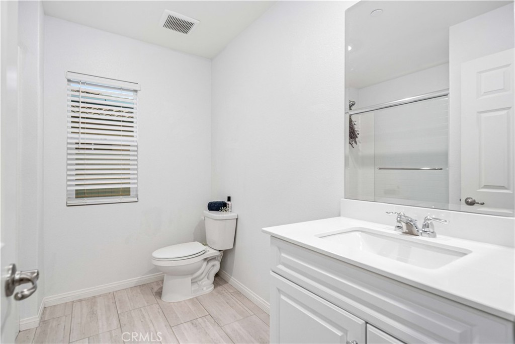 44451 63rd Street West Lancaster, CA 93536 - Photo 26 of 47 a bathroom with a sink a toilet and a window