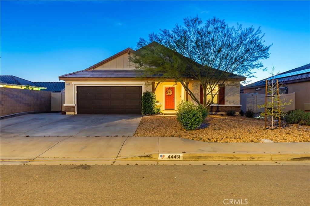 44451 63rd Street West Lancaster, CA 93536 - Photo 3 of 47 a front view of a house with a yard