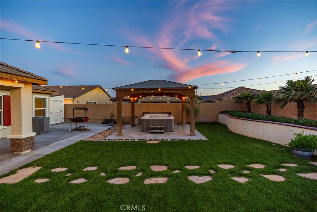 44451 63rd Street West Lancaster, CA 93536 - Photo 31 of 47 a view of a house with a big yard and potted plants