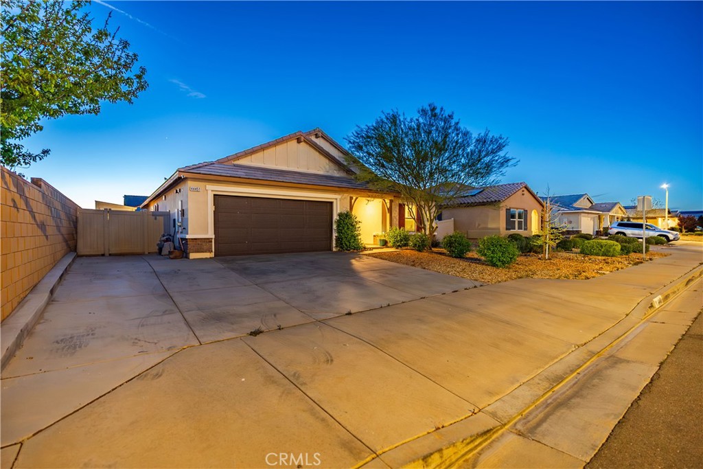 44451 63rd Street West Lancaster, CA 93536 - Photo 4 of 47 a front view of a house with a yard