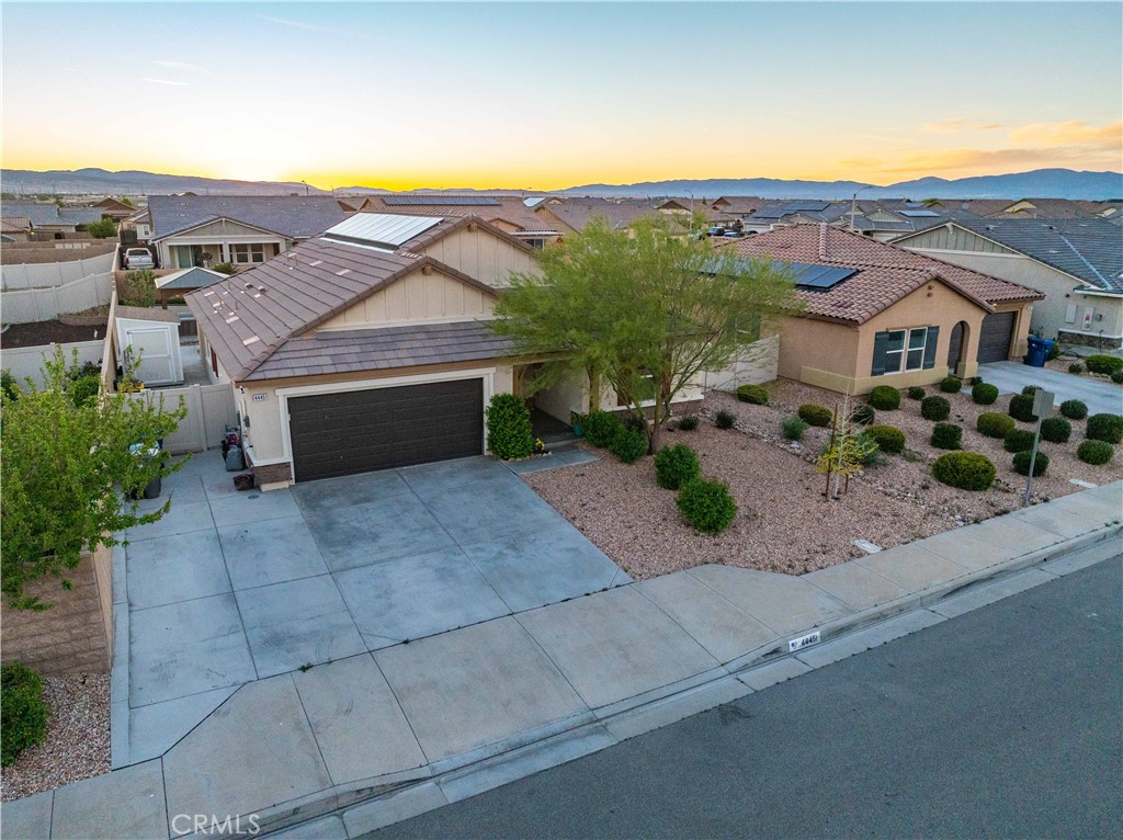 44451 63rd Street West Lancaster, CA 93536 - Photo 42 of 47 an aerial view of a house with a yard and a large tree