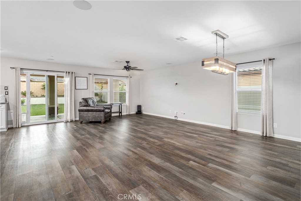 44451 63rd Street West Lancaster, CA 93536 - Photo 7 of 47 a view of empty room with wooden floor and fan