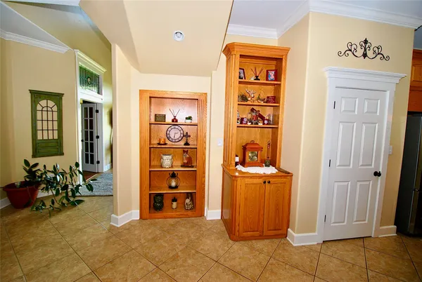 a dining hall with stainless steel appliances kitchen island granite countertop a table and chairs