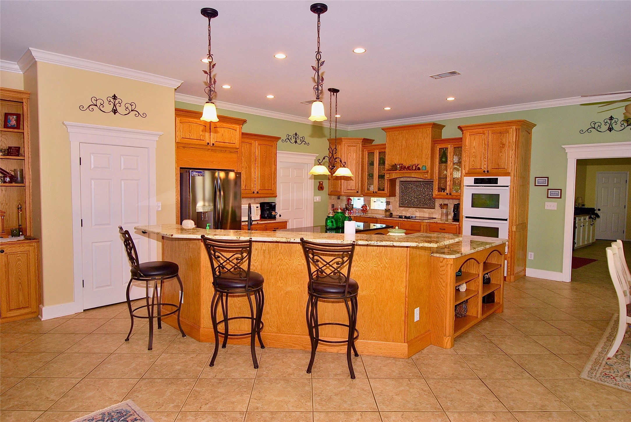 27368 Highway 19 Athens, TX 75752 - Photo 15 of 47 a dining hall with stainless steel appliances kitchen island granite countertop a table and chairs