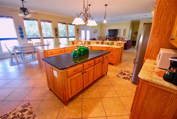 a bathroom with a granite countertop sink and a bathtub